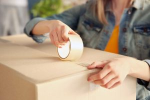 Woman taping a box