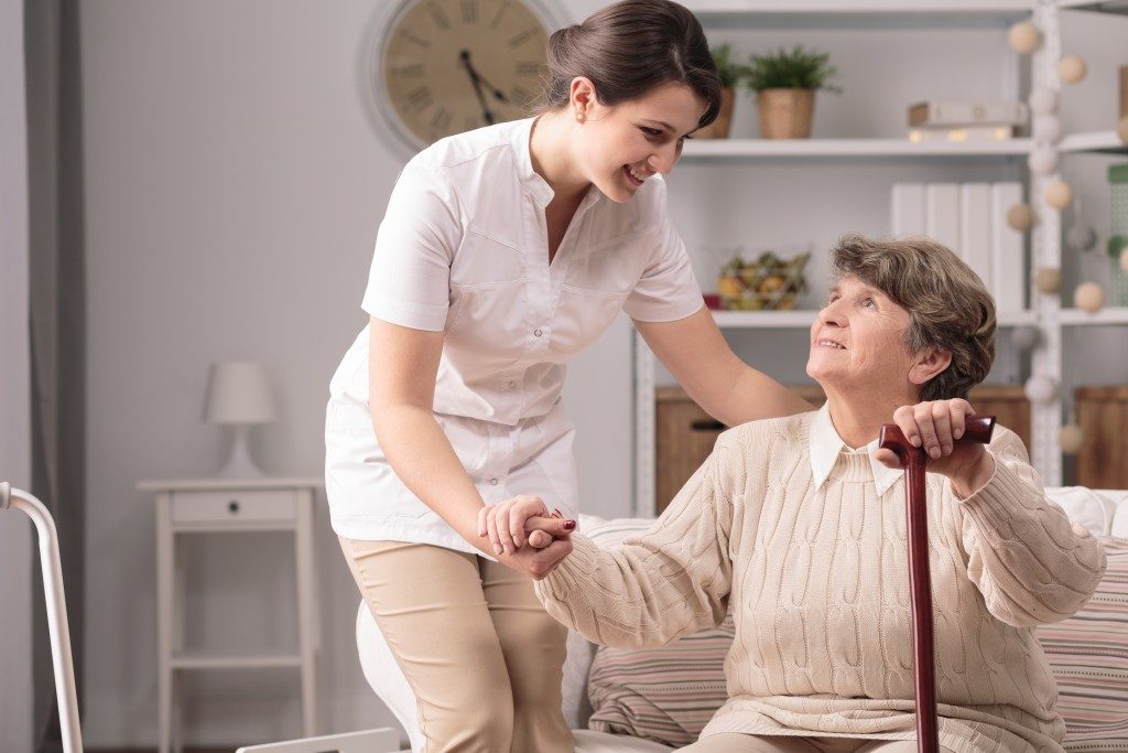 Caregiver assisting elder woman
