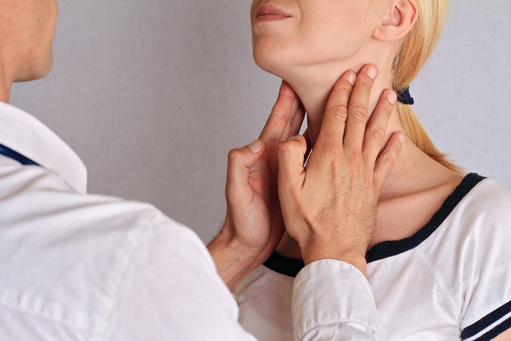 Doctor checking patient neck